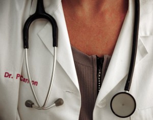 A physician with stethoscope poses on Oc